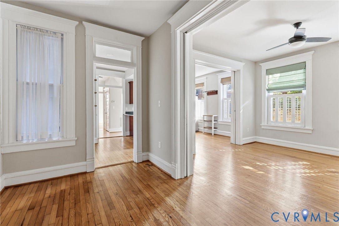 101 N Stafford Avenue, #U4, Stafford Terrace Condo, Richmond, VA 23220 Wood-finish flooring, tall windows with heavy woodwork trim, high ceilings, transoms above interior door frames, and a ceiling fan