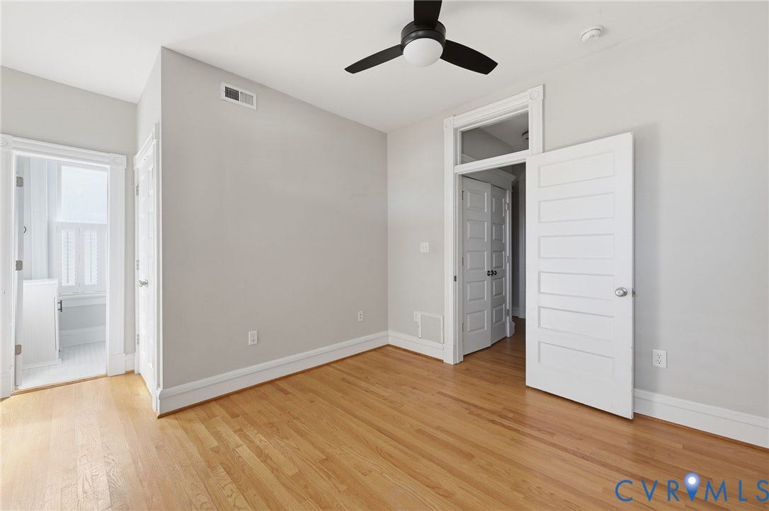 101 N Stafford Avenue, #U4, Stafford Terrace Condo, Richmond, VA 23220 Interior space featuring wood-finish flooring, a ceiling fan with integrated lighting, multi-panel doors, and a transom window