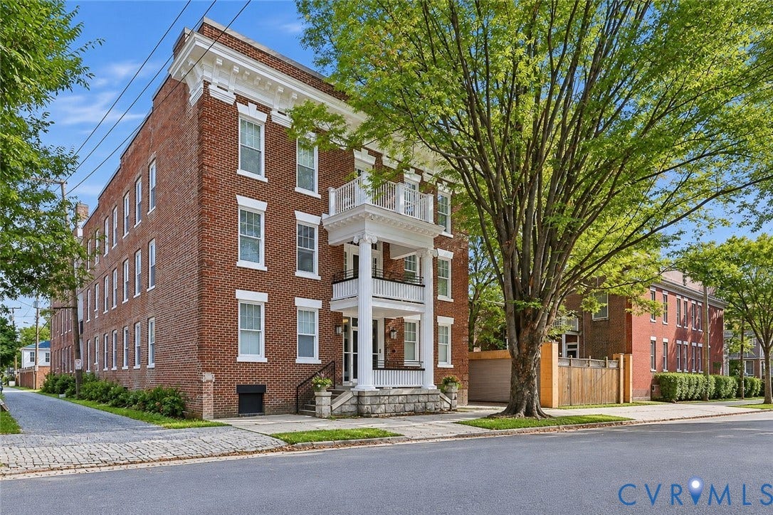 101 N Stafford Avenue, #U4, Stafford Terrace Condo, Richmond, VA 23220 Three-story brick exterior featuring a multi-level portico with classical columns, detailed cornice work, a stone foundation, and a cobblestone driveway