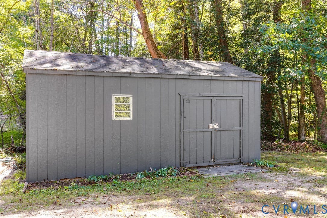3800 Pheasant Hollow Drive, Henrico, VA 23231 Standalone storage shed featuring vertical siding, dual swing doors, and a single window