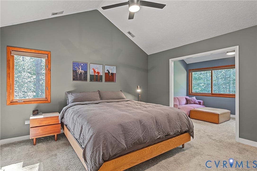 3800 Pheasant Hollow Drive, Henrico, VA 23231 Vaulted ceiling featuring a central lighted ceiling fan, neutral wall finishes, and wood-trim windows