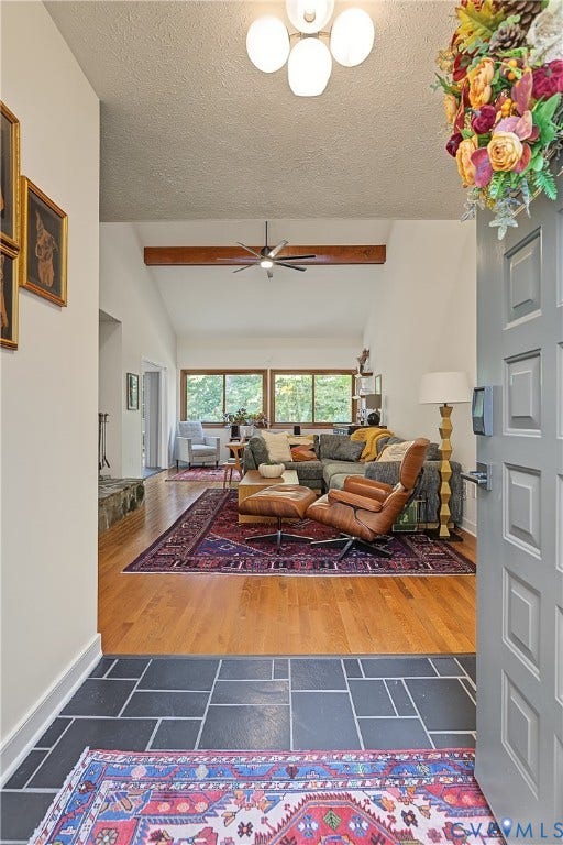 3800 Pheasant Hollow Drive, Henrico, VA 23231 Entryway featuring slate tile flooring, wood-finish flooring, vaulted ceilings, and a decorative exposed structural wood beam