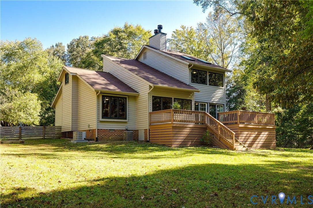 3800 Pheasant Hollow Drive, Henrico, VA 23231 Multi-level residence featuring light-toned horizontal siding, a multi-tiered wooden deck with railings, skylights, and a brick foundation element