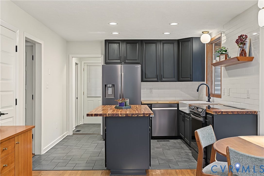 3800 Pheasant Hollow Drive, Henrico, VA 23231 Kitchen featuring dark cabinetry, butcher-block countertops, white subway tile backsplash, farmhouse-style sink, and tile flooring