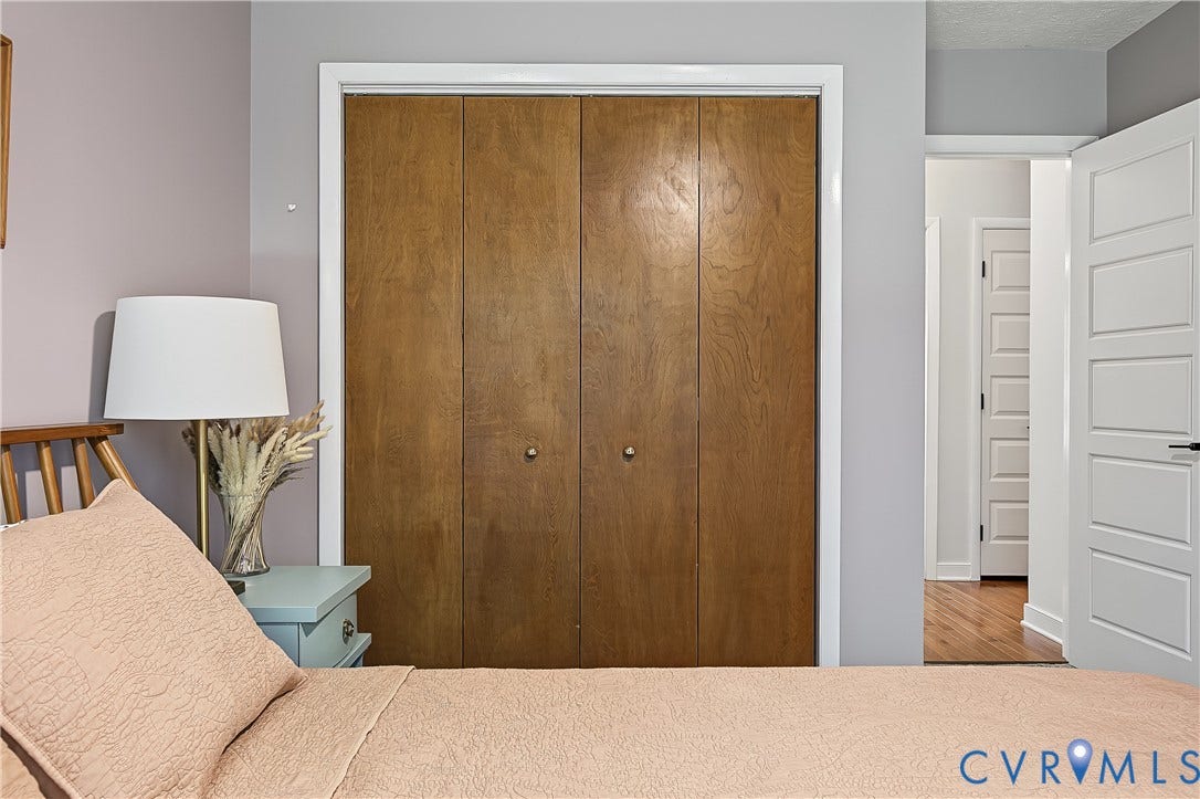 3800 Pheasant Hollow Drive, Henrico, VA 23231 Bi-fold closet doors with wood-grain finish, white door casing, and five-panel interior door