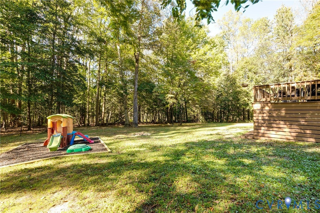 3800 Pheasant Hollow Drive, Henrico, VA 23231 Expansive backyard featuring a natural treeline, mature trees, and a wooden deck