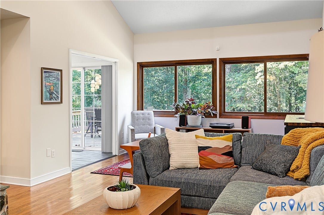 3800 Pheasant Hollow Drive, Henrico, VA 23231 Vaulted ceiling living area featuring wood-finish flooring and expansive windows with natural scenery