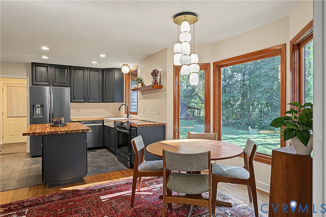 3800 Pheasant Hollow Drive, Henrico, VA 23231 Kitchen featuring dark cabinetry, butcher block countertops, an apron-front sink, multi-pendant lighting, and expansive windows