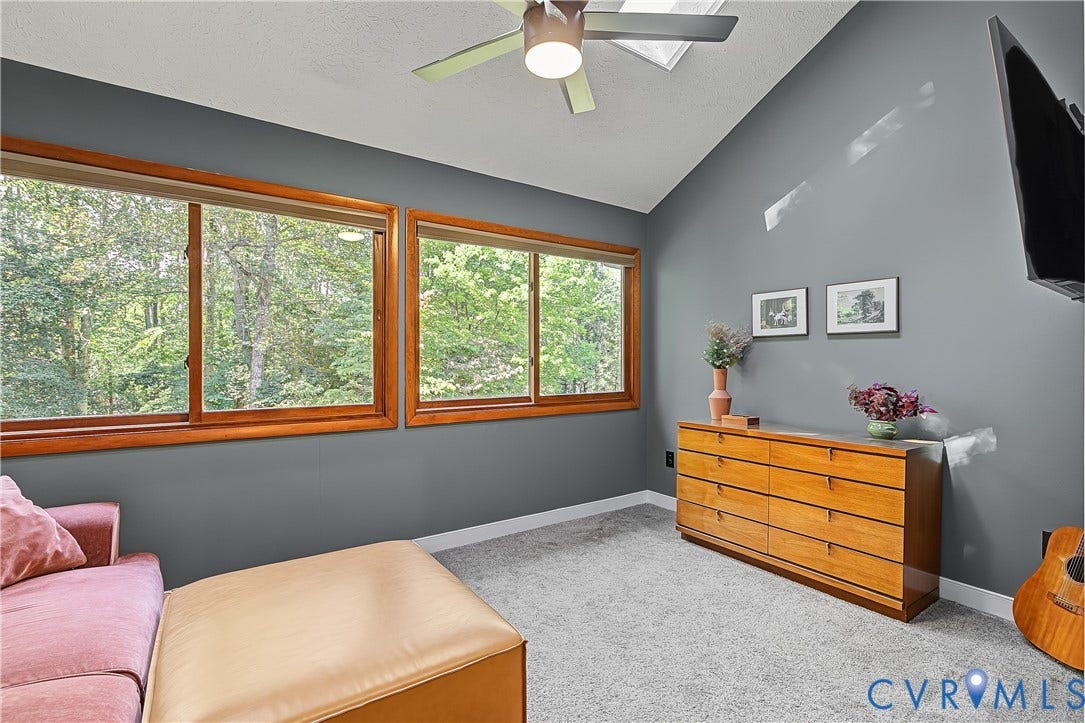 3800 Pheasant Hollow Drive, Henrico, VA 23231 Vaulted ceilings with a ceiling fan, skylight, and large horizontal windows with wood trim