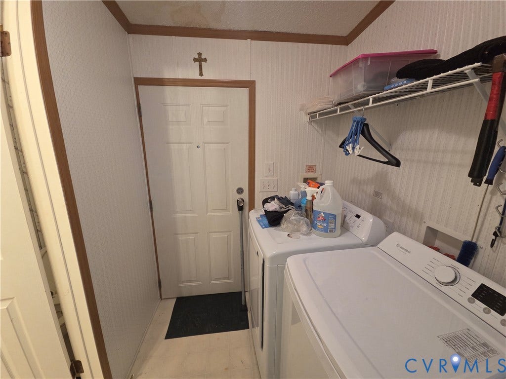 195 Concord Lane, Emporia, VA 23847 Laundry area featuring paneled walls, a six-panel exterior door, and built-in wire shelving
