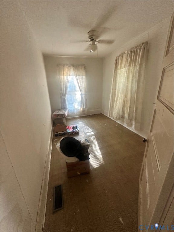 5 N Daisy Avenue, Henrico, VA 23075 Room featuring two windows, neutral walls, wood-finish flooring, and a ceiling-mounted fan