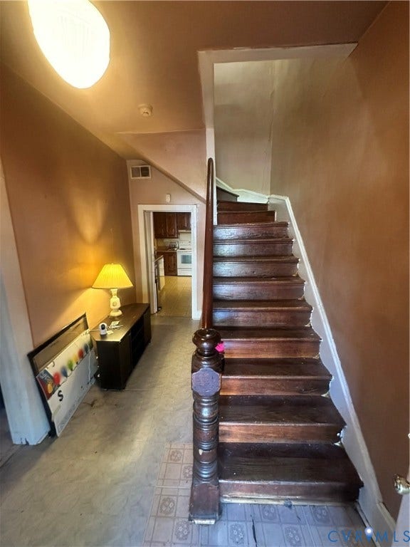 5 N Daisy Avenue, Henrico, VA 23075 Staircase featuring dark-stained wood treads and an ornate wood-turned newel post