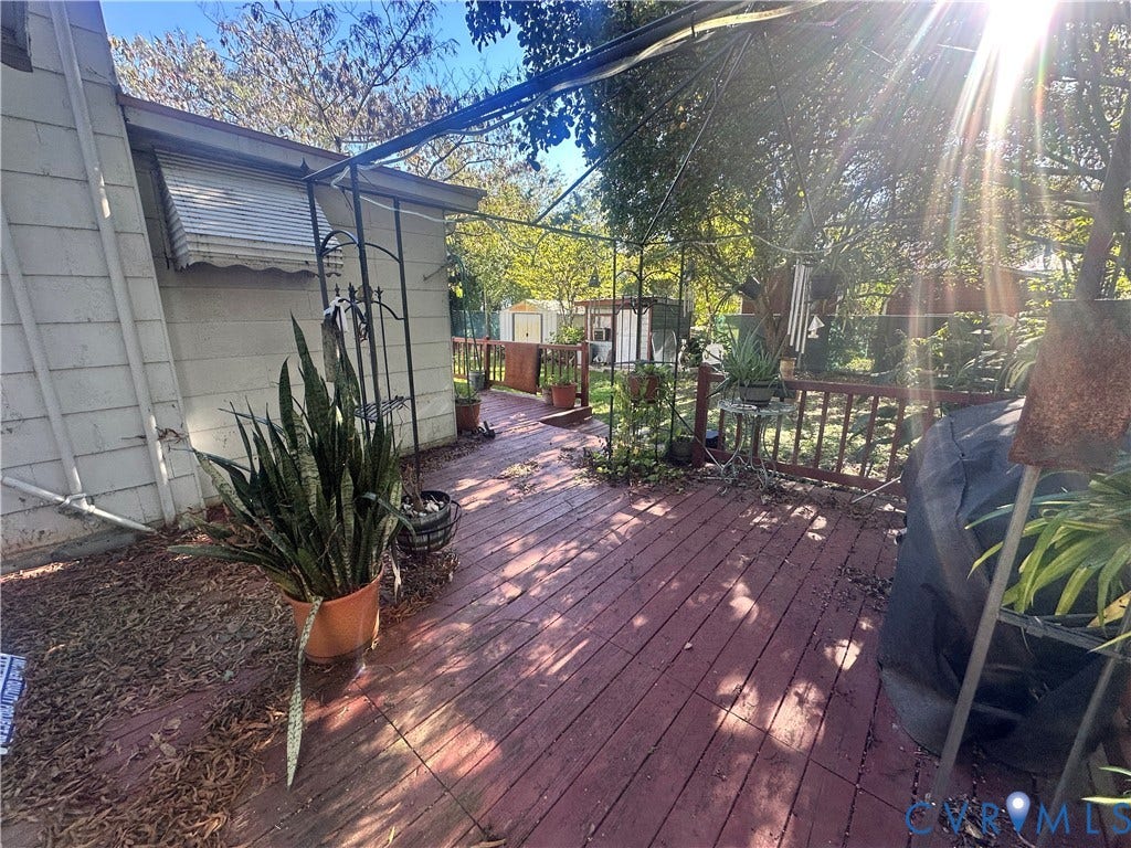 5 N Daisy Avenue, Henrico, VA 23075 Exterior wood deck featuring a metal-frame pergola and wood-slat railing