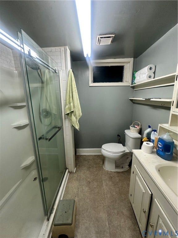 5 N Daisy Avenue, Henrico, VA 23075 Bathroom featuring a shower stall with a glass door, built-in vanity cabinet, recessed basin, and wall-mounted shelving
