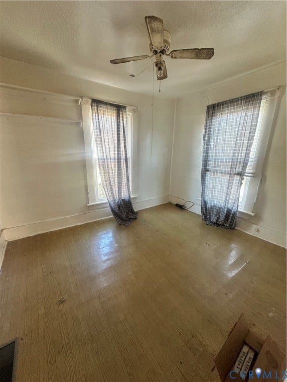 5 N Daisy Avenue, Henrico, VA 23075 Room featuring wood-finish flooring, two windows with traditional casings, and a ceiling-mounted fan