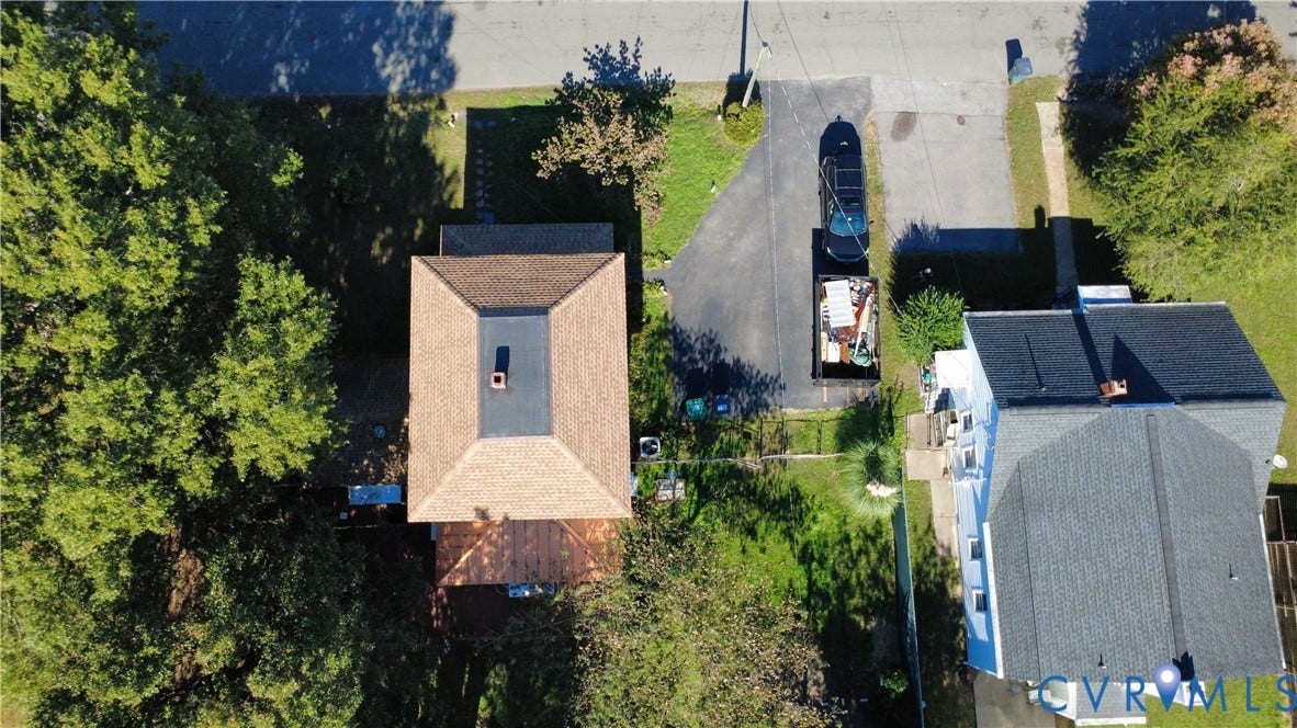 5 N Daisy Avenue, Henrico, VA 23075 Aerial perspective featuring a multi-level asphalt shingle roof, a dedicated paved driveway, and mature trees situated on the property grounds