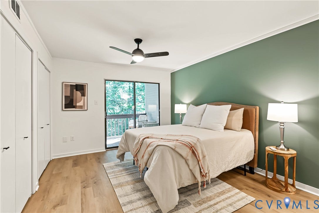 10272 Iron Mill Road, North Chesterfield, VA 23235 Wood-finish flooring, accent wall, ceiling fan with integrated lighting, dual-panel closet doors, and sliding glass door
