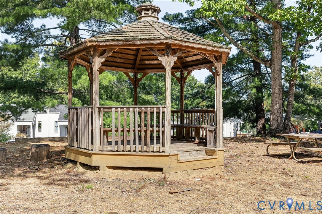 10272 Iron Mill Road, North Chesterfield, VA 23235 Wooden octagonal gazebo featuring shingle roofing, decorative wood brackets, and built-in perimeter bench seating