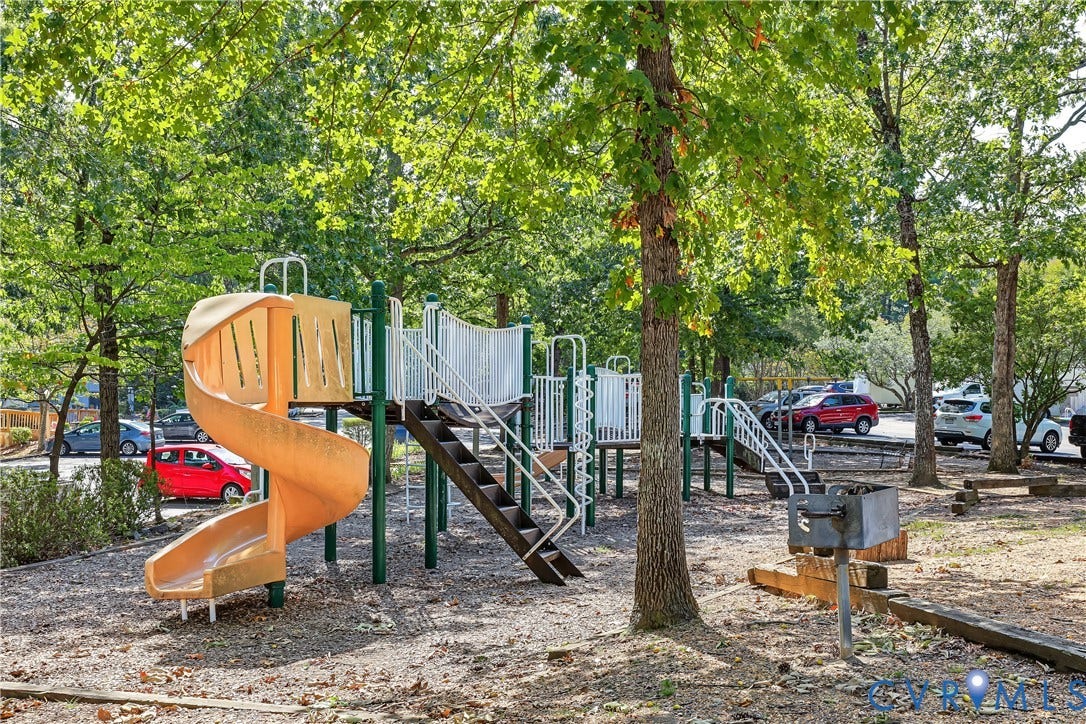 10272 Iron Mill Road, North Chesterfield, VA 23235 Recreational area featuring a spiral slide, climbing structure, metal stairs, and a built-in charcoal grill