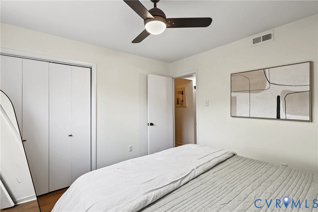 10272 Iron Mill Road, North Chesterfield, VA 23235 Room featuring neutral wall paint, wood-finish flooring, a ceiling fan with integrated lighting, and white bifold closet doors