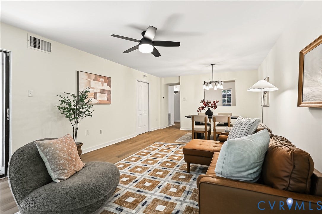 10272 Iron Mill Road, North Chesterfield, VA 23235 Living area featuring wood-finish flooring, a contemporary multi-blade ceiling fan with integrated lighting, and a multi-light metal chandelier
