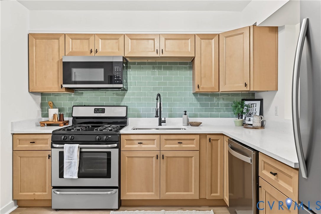 10272 Iron Mill Road, North Chesterfield, VA 23235 Kitchen featuring light wood cabinetry, white countertops, a sage green subway tile backsplash, a matte black gooseneck faucet, and stainless steel appliances