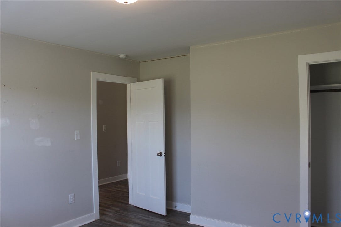 118 Clements Drive, Essex, VA 22560 Neutral-toned interior space featuring three-panel shaker-style interior doors, overhead flush-mount lighting, and wood-finish flooring