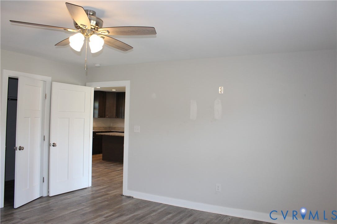 118 Clements Drive, Essex, VA 22560 Interior space featuring wood-finish flooring, a ceiling fan with integrated lighting, and white shaker-style panel doors