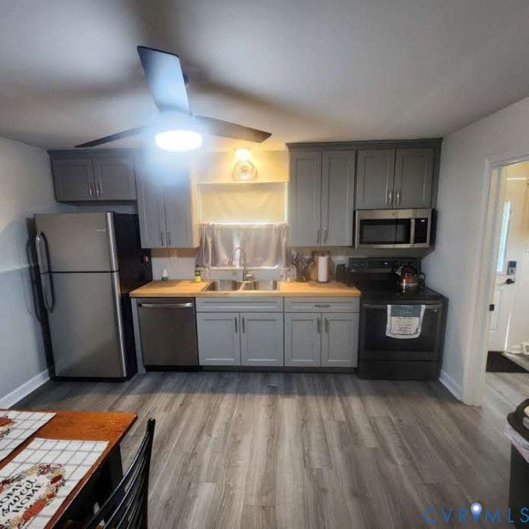 9005 Pine Hill Road, Hanover, VA 23116 Kitchen featuring grey shaker-style cabinetry, wood-finish countertops, stainless steel appliances, dual-basin sink with pull-down faucet, and wood-finish flooring