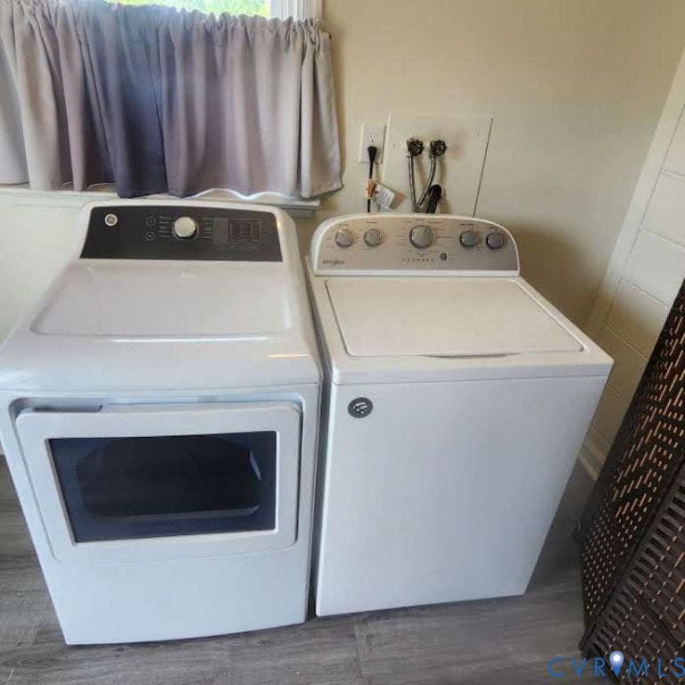 9005 Pine Hill Road, Hanover, VA 23116 Dedicated laundry area featuring a top-load washer and front-load dryer with wood-finish flooring