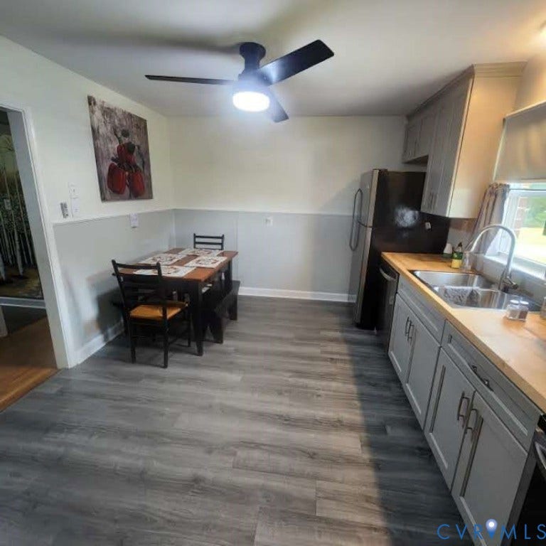9005 Pine Hill Road, Hanover, VA 23116 Kitchen featuring grey cabinetry, wood-finish flooring, wood-toned countertops, a stainless steel double-basin sink, and a ceiling-mounted fan with integrated lighting