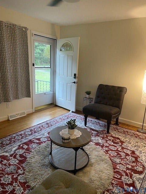 9005 Pine Hill Road, Hanover, VA 23116 Wood-finish flooring, white paneled entry door with arched decorative glass insert, and exterior screen door