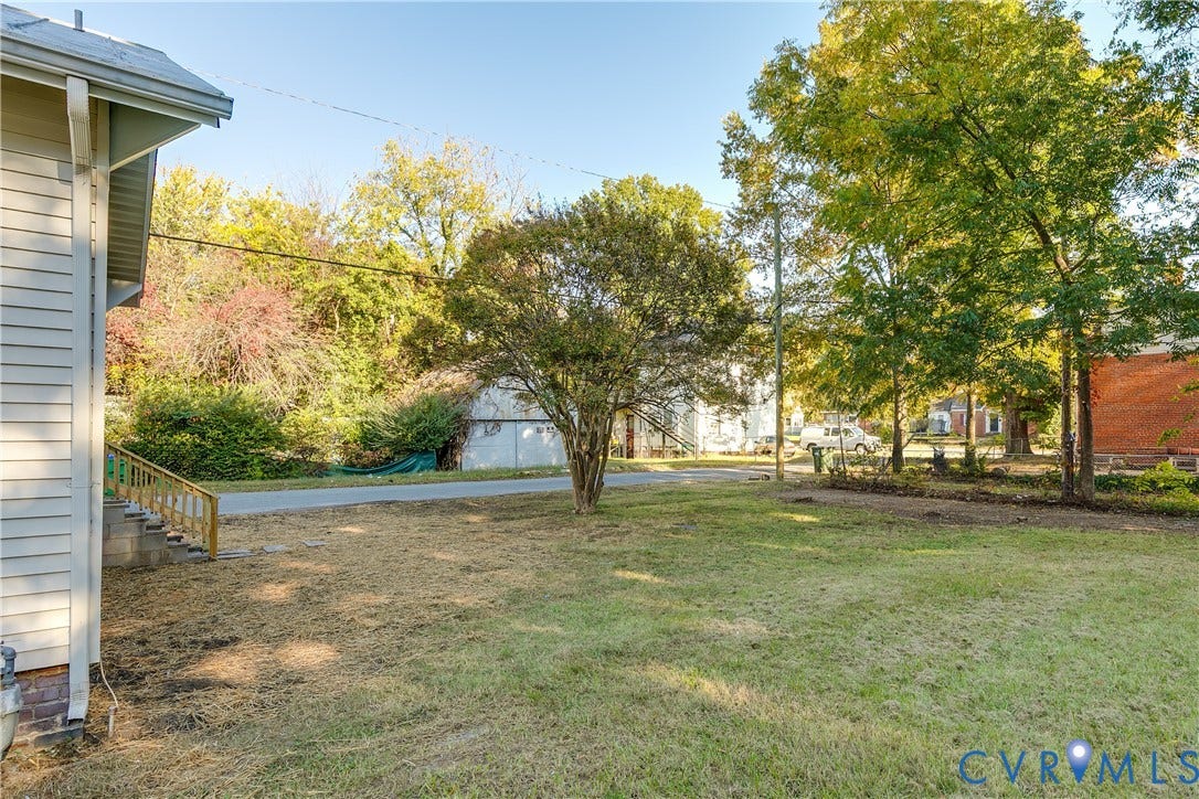 3500 Stockton Street, Weisigers Plan, Richmond, VA 23224 Exterior space featuring siding, mature trees, and wooden staircase railing