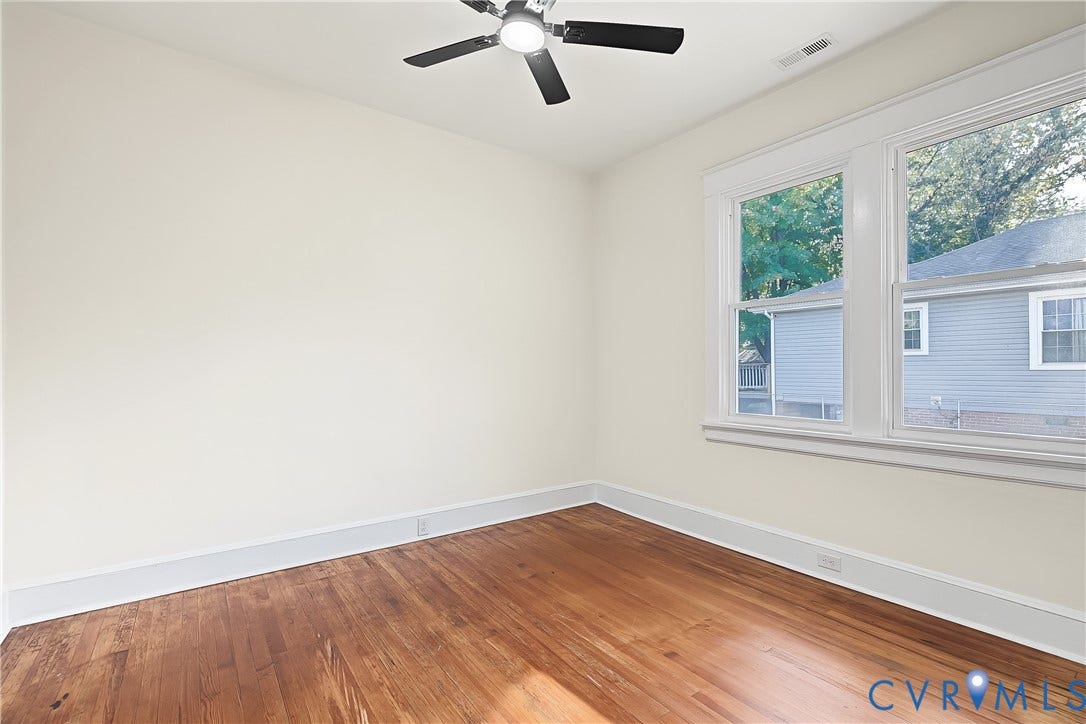 3500 Stockton Street, Weisigers Plan, Richmond, VA 23224 Room featuring wood-finish flooring, multi-pane windows with casing, and a ceiling-mounted fan with integrated lighting