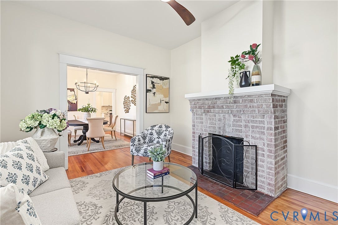 3500 Stockton Street, Weisigers Plan, Richmond, VA 23224 Living area featuring a floor-to-ceiling brick fireplace with a custom mantle, wood-finish flooring, and crown molding