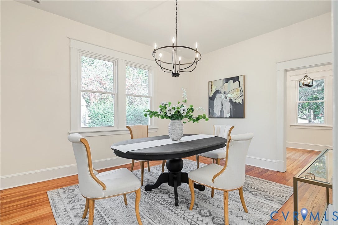 3500 Stockton Street, Weisigers Plan, Richmond, VA 23224 Dining area featuring wood-finish flooring, a matte black circular chandelier, and natural light provided by dual-pane windows with thick casing trim
