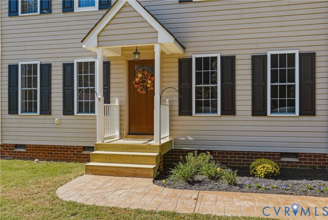 308 N Snead Street, #A, Ashland, VA 23005 Exterior entrance featuring horizontal siding, dark decorative shutters, a covered entryway porch and a stamped concrete walkway