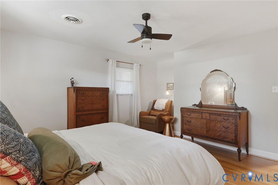 9 E 31st Street, Richmond, VA 23224 Neutral interior featuring wood-finish flooring, a matte black ceiling fan, and a single-window configuration