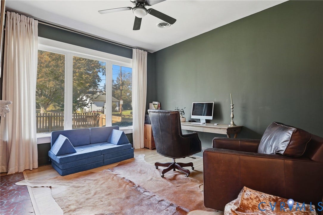 9 E 31st Street, Richmond, VA 23224 Large picture window with natural light, wood-finish flooring, ceiling fan, and painted accent wall