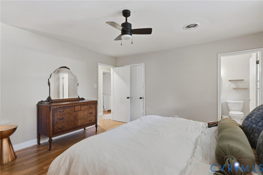 9 E 31st Street, Richmond, VA 23224 Room featuring wood-finish flooring, a matte black ceiling fan with integrated lighting, and neutral wall paint