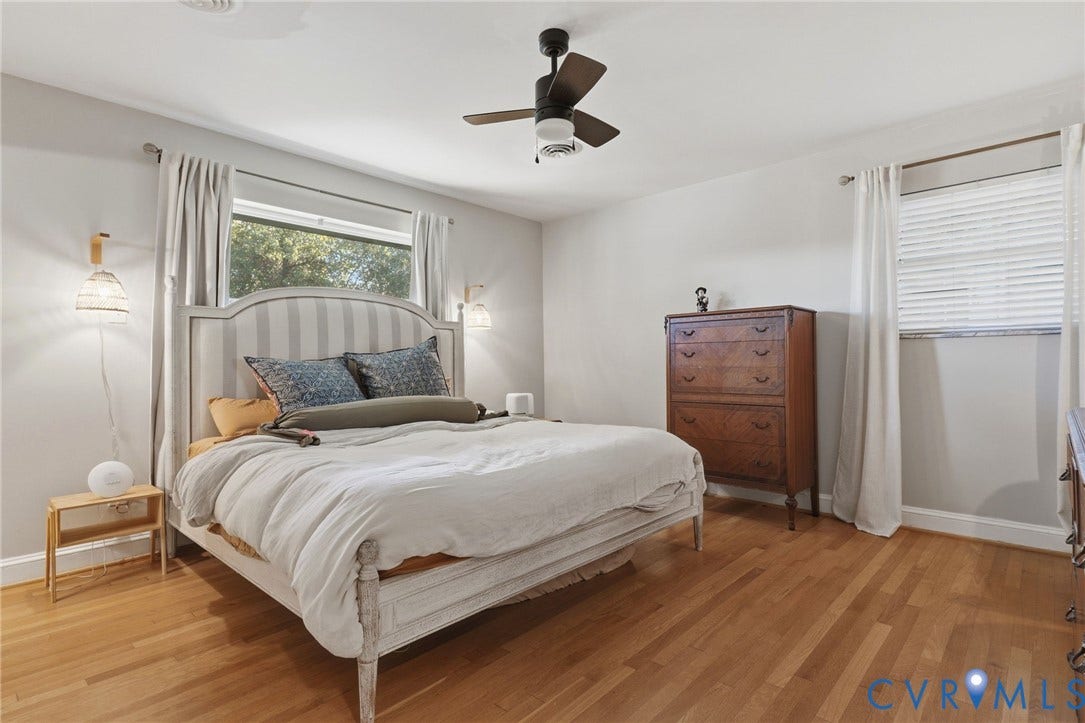 9 E 31st Street, Richmond, VA 23224 Wood-finish flooring, central ceiling fan with integrated lighting, and dual wall-mounted light fixtures