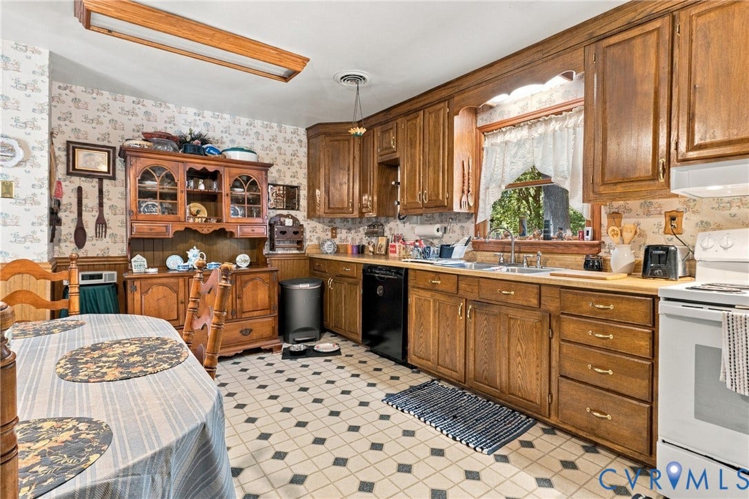 8840 Black Creek Road, New Kent, VA 23141 Kitchen featuring wood cabinetry, built-in hutch, tiled flooring, and window above the sink