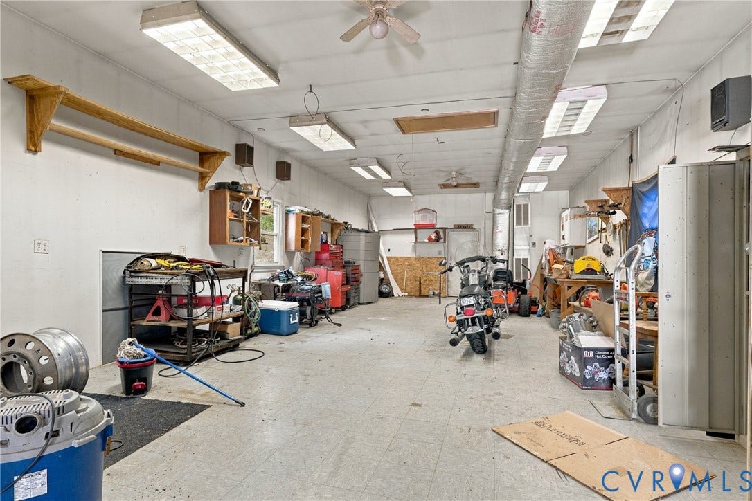 8840 Black Creek Road, New Kent, VA 23141 Multi-car garage featuring recessed lighting, ceiling-mounted fan, and integrated wall shelving