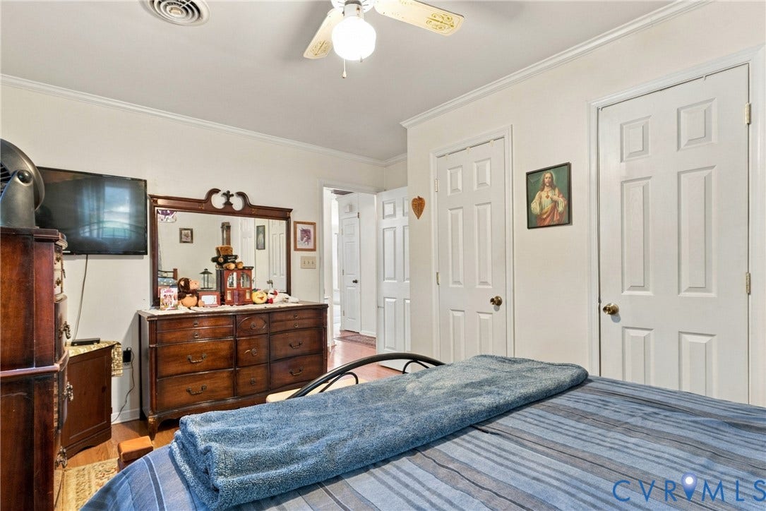 8840 Black Creek Road, New Kent, VA 23141 Interior room featuring crown molding, neutral wall finishes, solid-core six-panel interior doors, and a ceiling-mounted light fixture with integrated fan