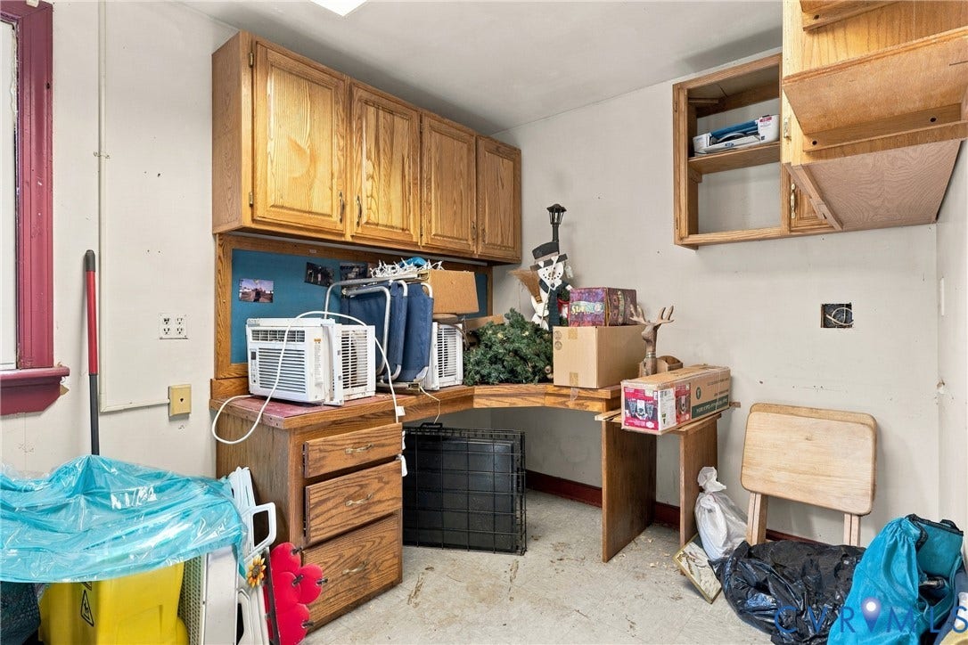8840 Black Creek Road, New Kent, VA 23141 Built-in wood-finish cabinetry featuring upper wall-mounted storage and an integrated wrap-around desk surface with multi-drawer storage