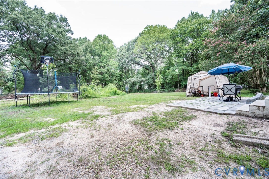 1818 Arlington Road, Hopewell, VA 23860 Spacious backyard featuring a stone paver patio and mature perimeter trees