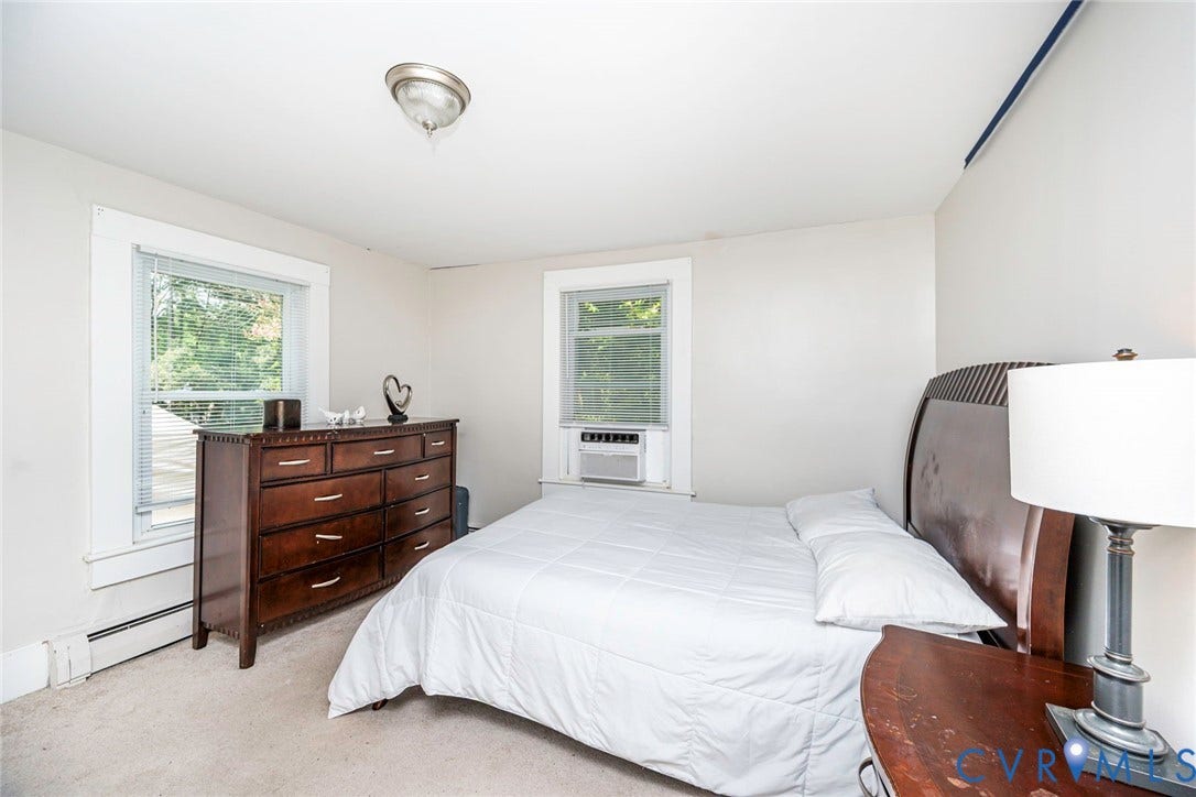 1818 Arlington Road, Hopewell, VA 23860 Room featuring neutral-toned walls, dual windows with white trim, and a flush-mount ceiling fixture