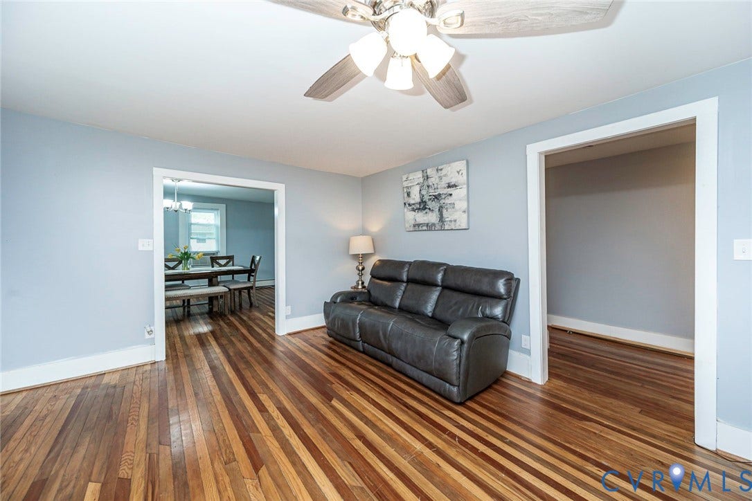 1818 Arlington Road, Hopewell, VA 23860 Wood-finish flooring, multi-tonal hardwood planks, ceiling fan with light fixture, and wide decorative door casing