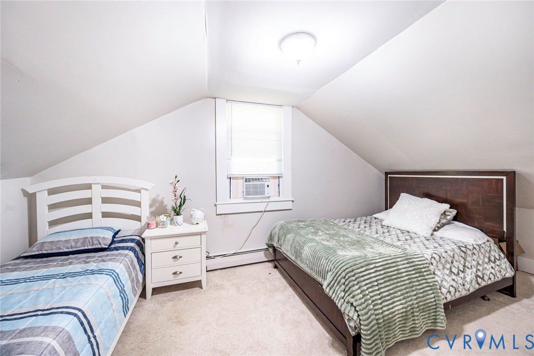 1818 Arlington Road, Hopewell, VA 23860 Vaulted ceiling with neutral wall finish, wall-to-wall carpeting, and a centrally positioned window with white trim