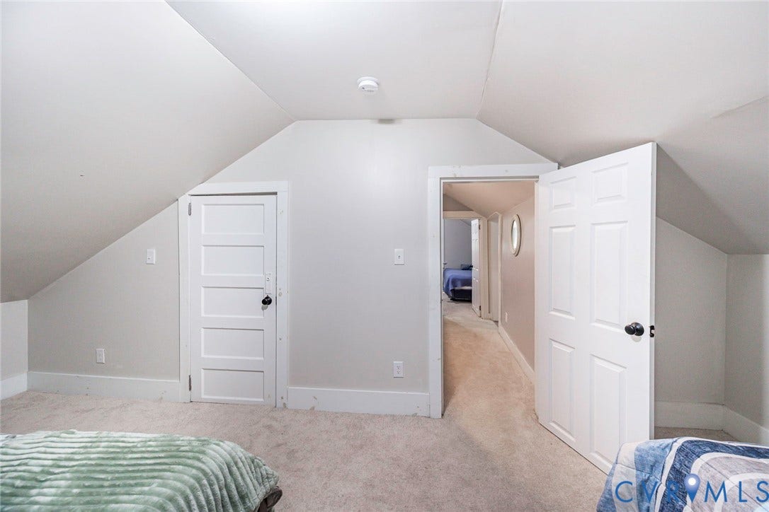 1818 Arlington Road, Hopewell, VA 23860 Sloped ceiling architecture featuring neutral-toned carpet, a five-panel interior door, and a double-panel door